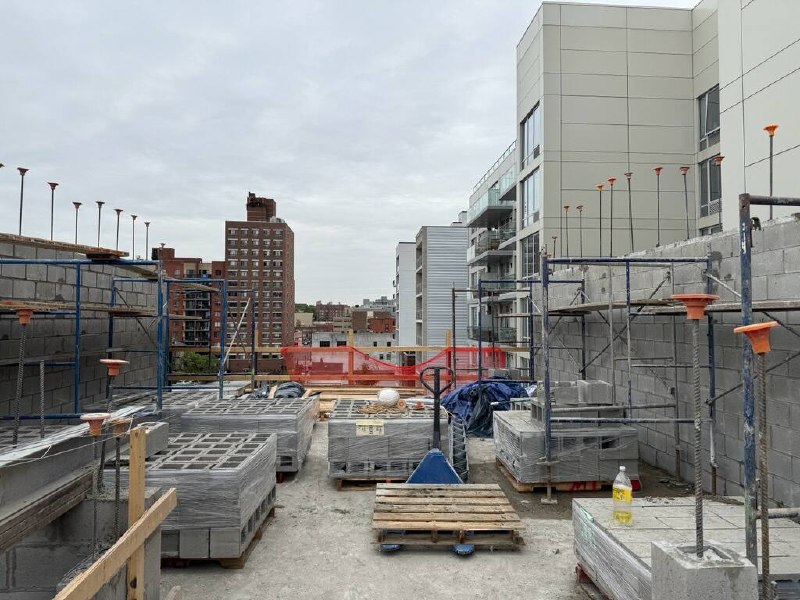 Staged CMU pallets on rooftop construction site