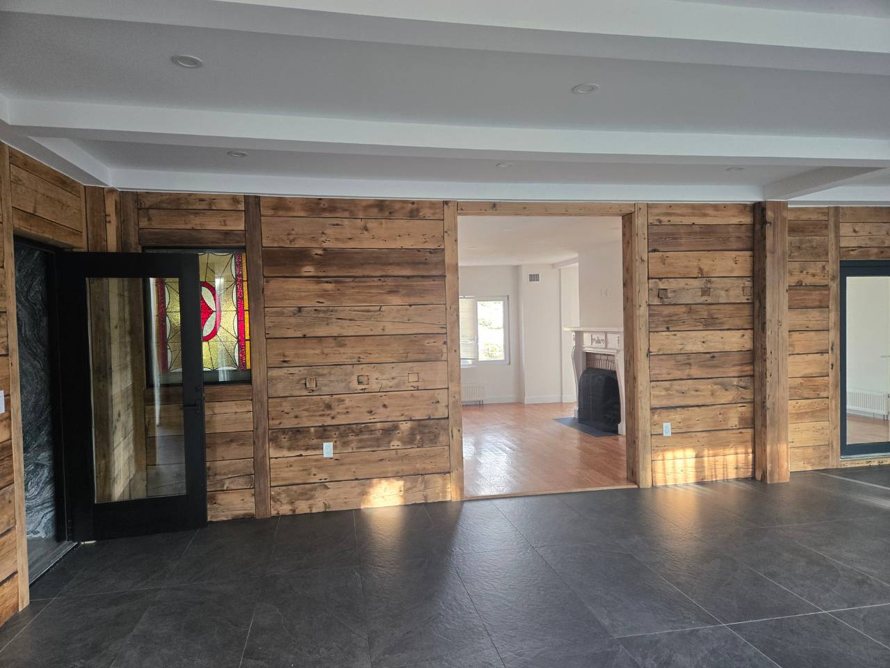 Reclaimed wood foyer with stained-glass entry