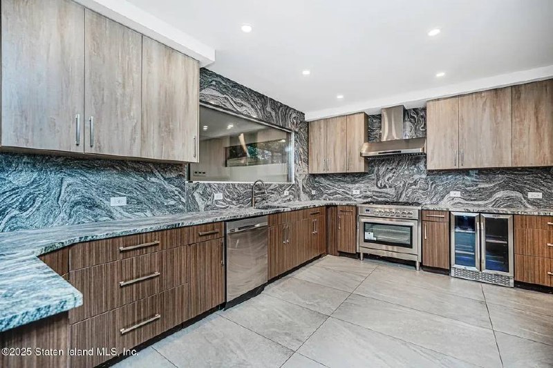Full-slab marble kitchen with walnut cabinetry